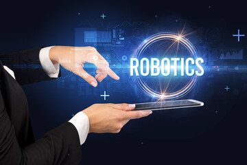 Close-up of a touchscreen with ROBOTICS inscription, new technology concept