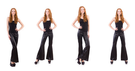 Fototapeta premium Redhead woman in black bell bottom pants on white