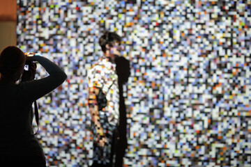 Man on the background of the projection of colored pixels