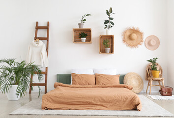 Stylish interior of bedroom with houseplants