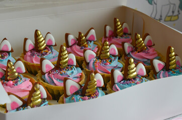 Beautiful delicious multicolored cupcakes for children's holiday table