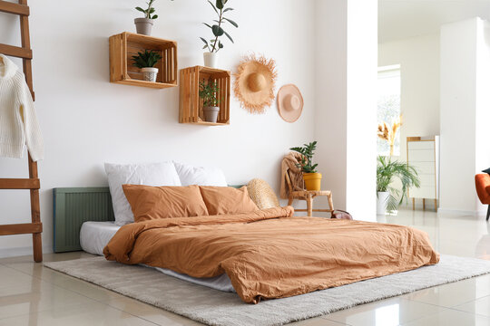Stylish interior of bedroom with houseplants