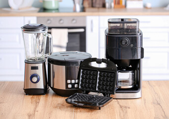 Different household appliances on table in kitchen