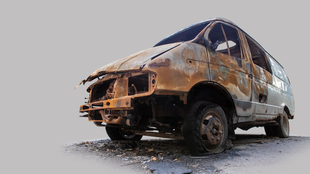 Burnt Out Delivery Van Isolated On Grey Background