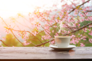 Coffee espresso on wood table nature background in garden,warm tone