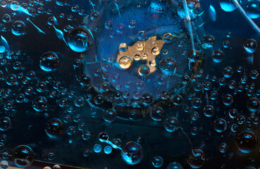Turquoise spheres are located on a blue background with gold hole. Space abstraction.