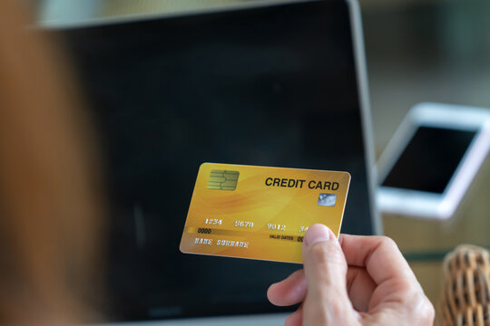  Online shopping concept.Close up of hand woman holding credit card and using laptop computer  for online shopping .