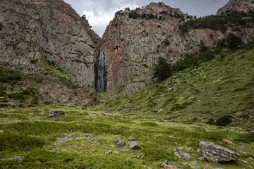 Impressive waterfall Abau Su flowing from high cliff in the Caucasus. Kabardino-Balkaria, Russia.