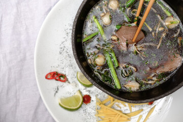 Traditinal vietnamese pho bo soup with vegetables and beef