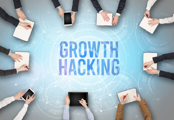 Group of people in front of a laptop with GROWTH HACKING insciption, web security concept