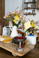 Autumn interior and still life. Pumpkins, apples, zucchini, autumn leaves and flowers. Background. Postcard. Flat lay.
