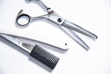 Professional tools for hairdresser, barber. Scissors, blade, comb on a white background.