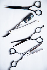 Professional tools for hairdresser, barber. Scissors, blade, comb on a white background.