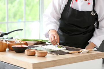 Beautiful Asian chef cooking in kitchen, closeup