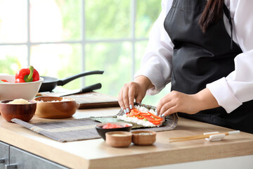 Obraz na płótnie Canvas Beautiful Asian chef cooking in kitchen, closeup