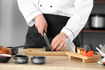 Handsome Asian chef cooking in kitchen, closeup