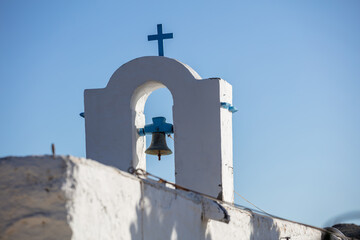 Small church belfry detail, white and blue colors on clear blue sky background. Greece. Kea island.