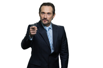 Serious mature chief pointing with his finger. Confident businessman isolated on white background.
