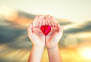woman hands holds red heart
