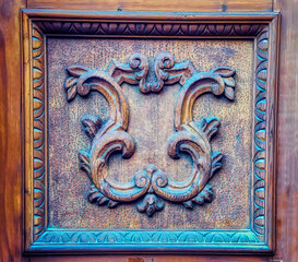 Vintage ornamental wood decoration on entrance door.
