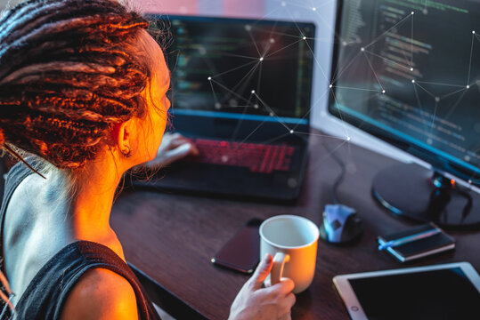 Modern young female programmer is writing program code on a laptop at home. The concept of software development.