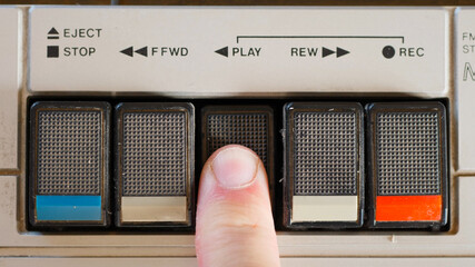 Pressing Play Button on a Retro Cassette Player