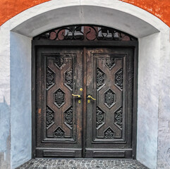 Old lock and handle on rustic wooden door. Natural texture of old wooden door with old lock and handle.