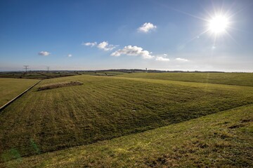 Green field and  bright sun and underground storage center of radioactive waste under the field.  France, Cherbourg. .