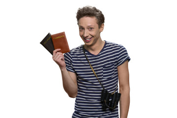 Portrait of smiling teenage travaler holding passports. Isolated on white background.