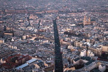 Obraz premium Aerial view of Paris cityscape - wide road and many streets and buildings. Towers of the roman catholic Church of Saint-Sulpice is on the right. .