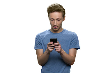 Portrait of young guy is typing message on his smartphone. Isolated on white background.