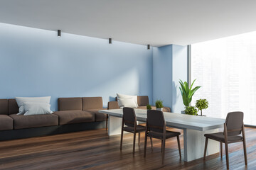 Panoramic blue dining room corner with sofa