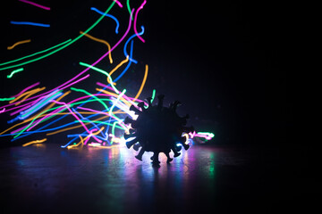 Coronavirus 2019-nCov novel coronavirus concept. Big Corona virus miniature model on wooden table with fog and backlight. Creative artwork decoration.