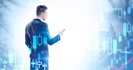 Man using smartphone in city, graph