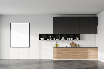 White kitchen with wooden cabinets and poster