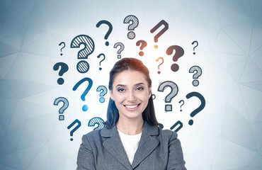 Smiling young woman, question marks