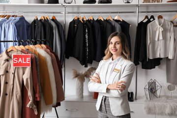 Female seller in modern clothes store