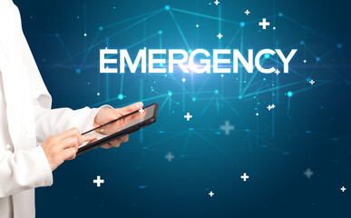 Doctor fills out medical record with EMERGENCY inscription, medical concept