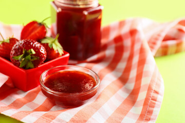 Bowl of tasty strawberry jam on table