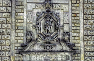Obraz premium Bas relief sculpture of little boy with cross at facade of religious building in Barcelona, Spain.