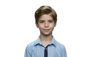 Smiling european white boy in blue shirt on white background. Kid male standing.