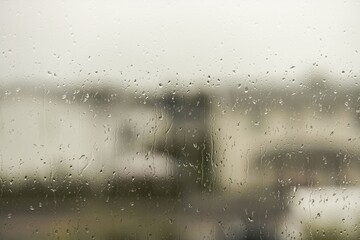 View of raindrops running on window glass. Beautiful nature backgrounds.