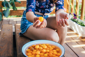 young girl holding yellow fruits in her hands, healthy breakfast, snack.