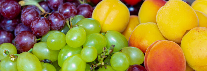 Ripe cherries, grapes and apricots. Fruit plate. Bright fruits