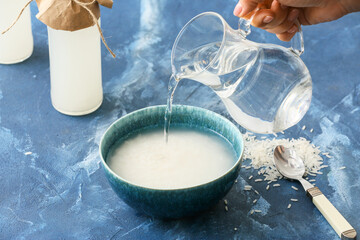 Preparing of rice water on color background