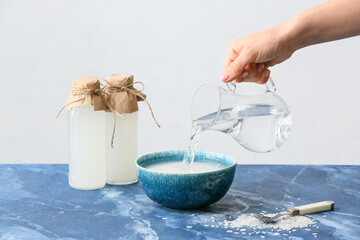 Woman preparing rice water on table