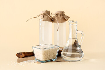 Bottles of rice water on color background