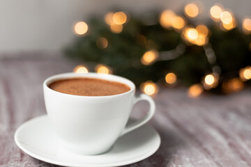 Obraz na płótnie Canvas cup of cappuccino with Christmas lights