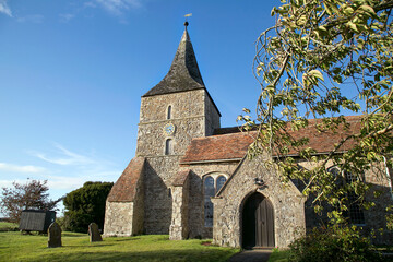 St Mary in the Marsh is an Anglican Church in New Romney - Kent. It has a traditional clock tower and spire which was added in the 15th century.