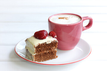 slice of chocolate strawberry pie and a red cup of frothy cappuccino on a plate. sweet and hot summer morning
